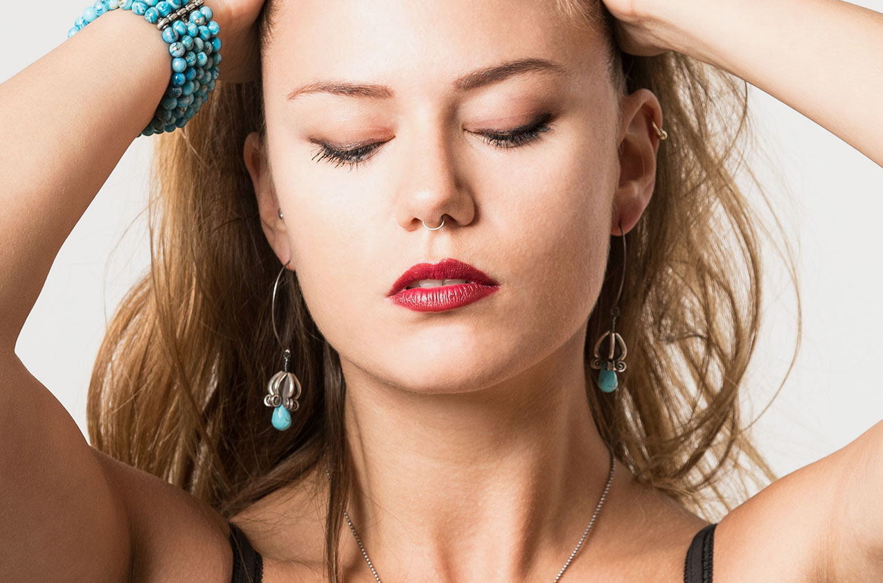 Blonde Model wearing Silver & Stone. Artisan turquoise earrings