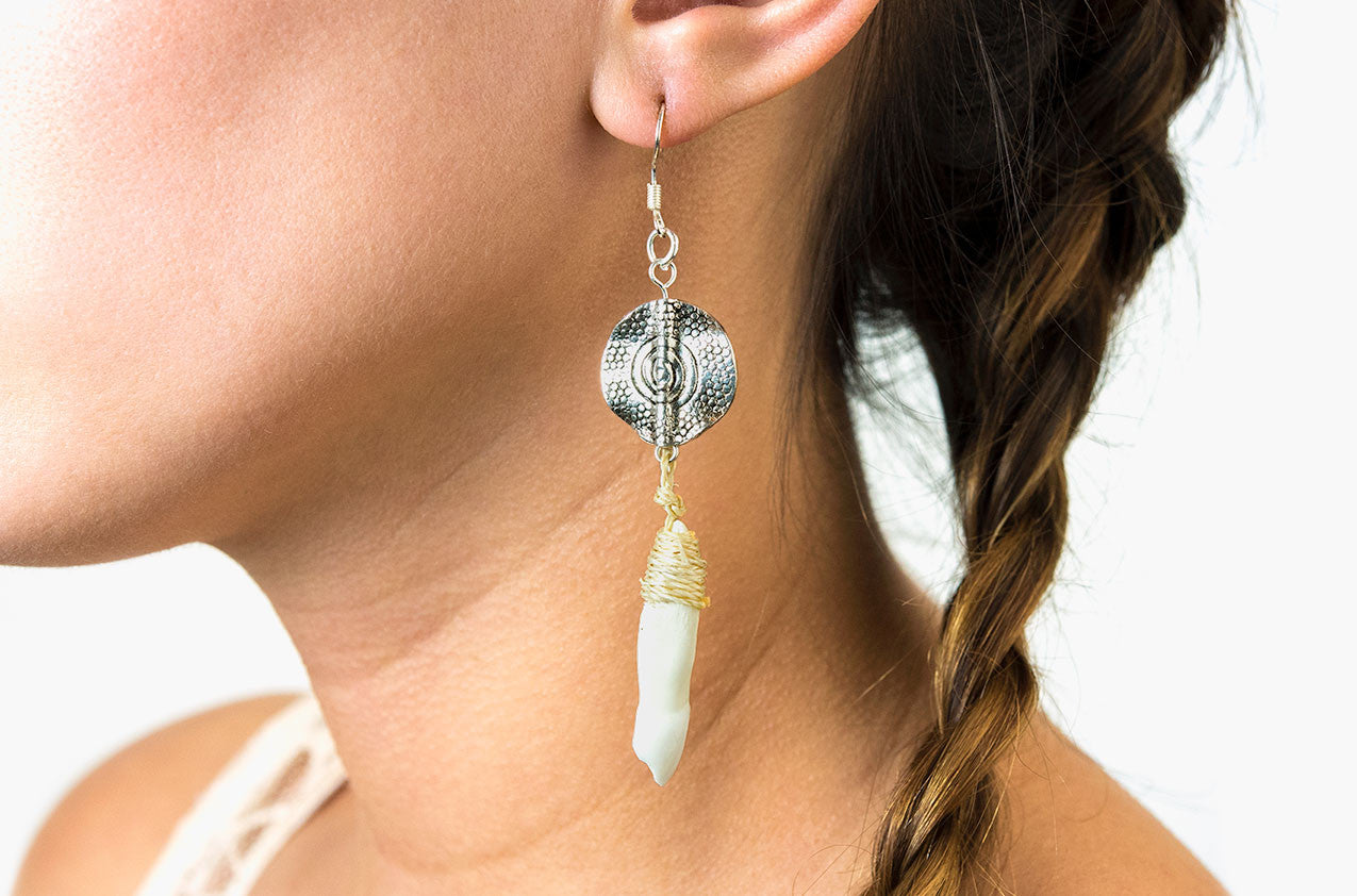 Model wearing Metal & Bone. Tribal drop earrings