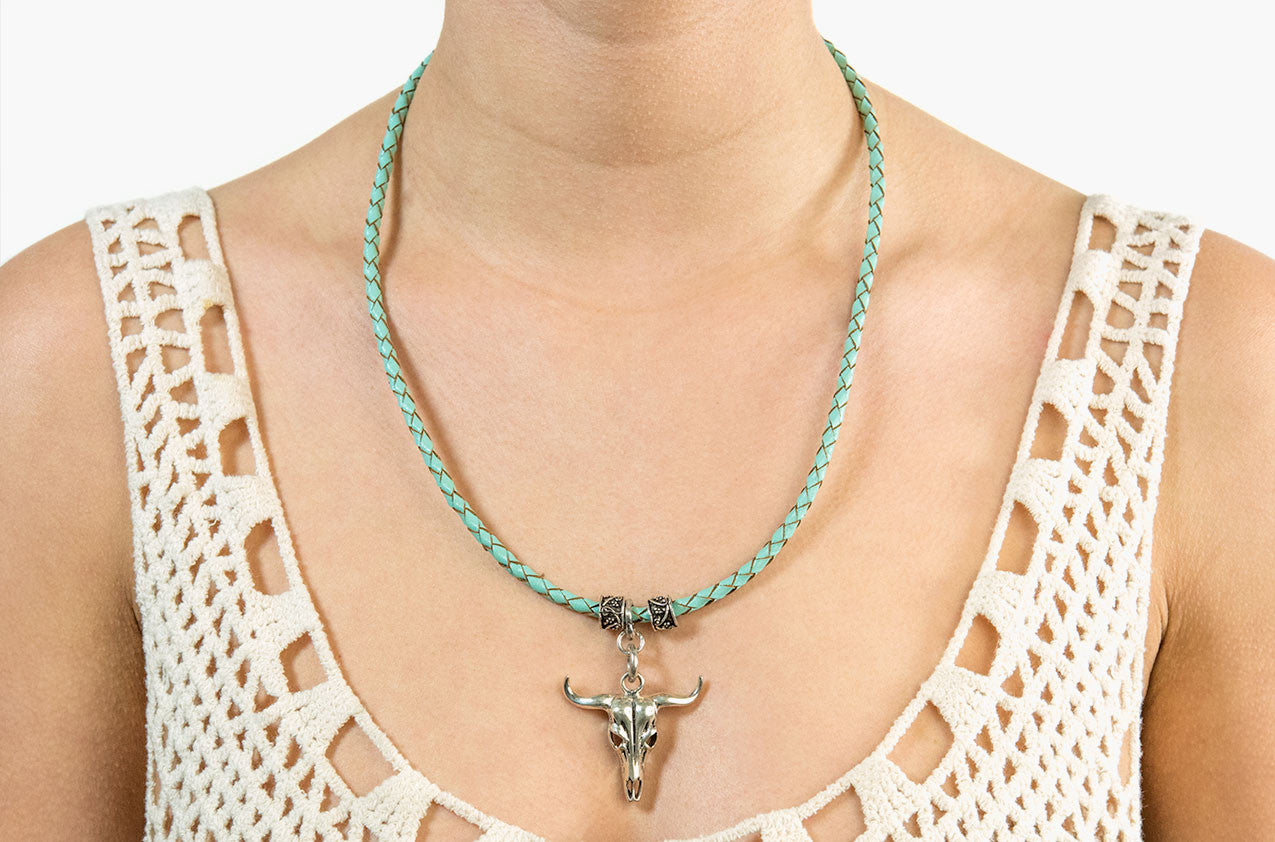 Model wearing Long-horn & Leather. Sterling steer necklace in aqua