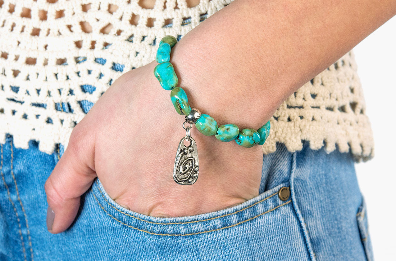 Model wearing Turquoise nuggets and tribal charm bracelet
