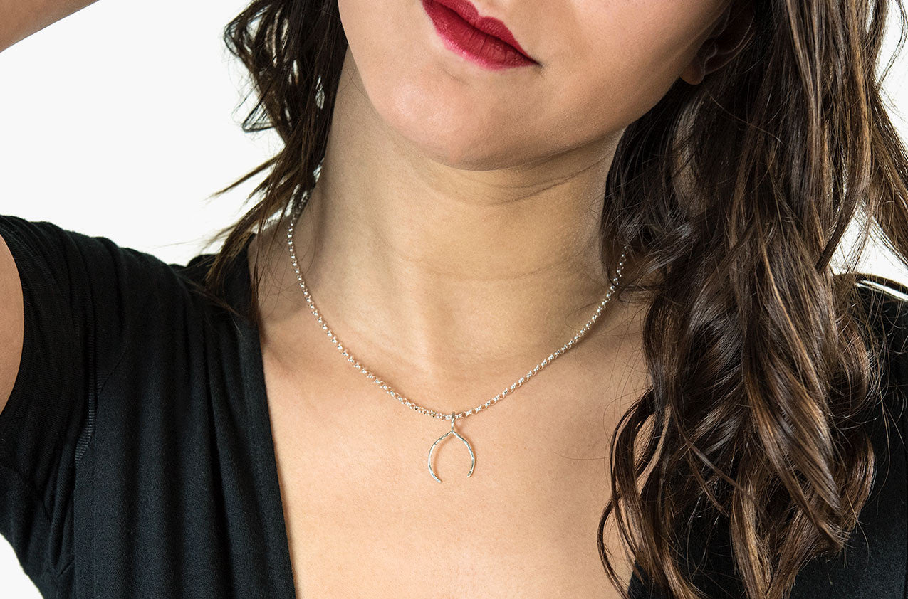 Model wearing Wishbone necklace in sterling silver