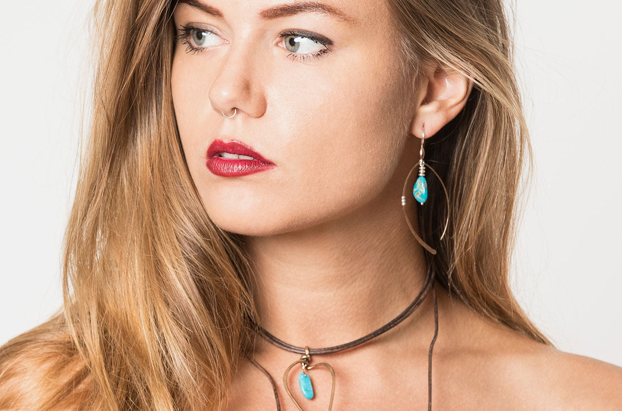 Blonde Model wearing Metal & Stone. Artisan arches earrings Copper earwires