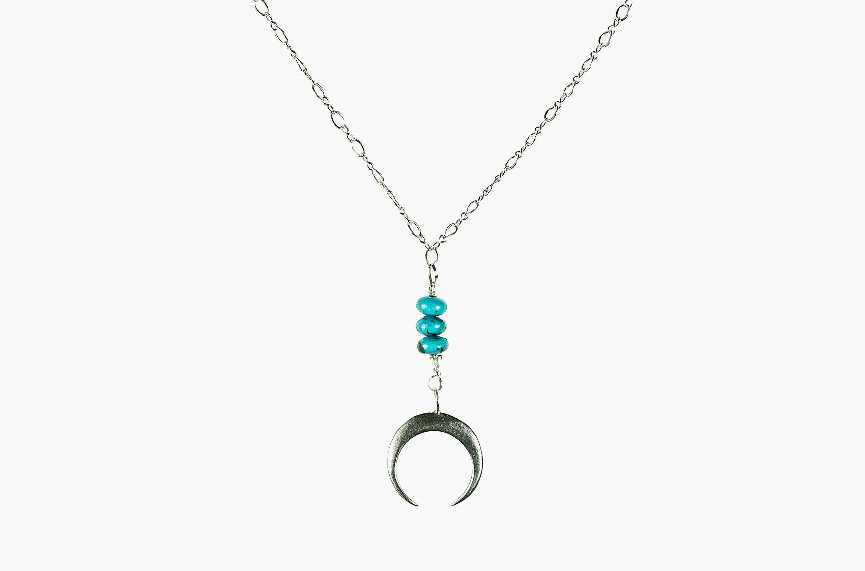 Metal & Stone. Turquoise and precious metal crescent silver