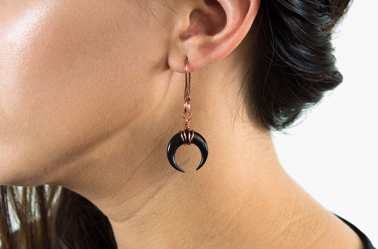Model wearing Little Big Horn. Crescent medium wire-wrap earrings Black with copper earwires