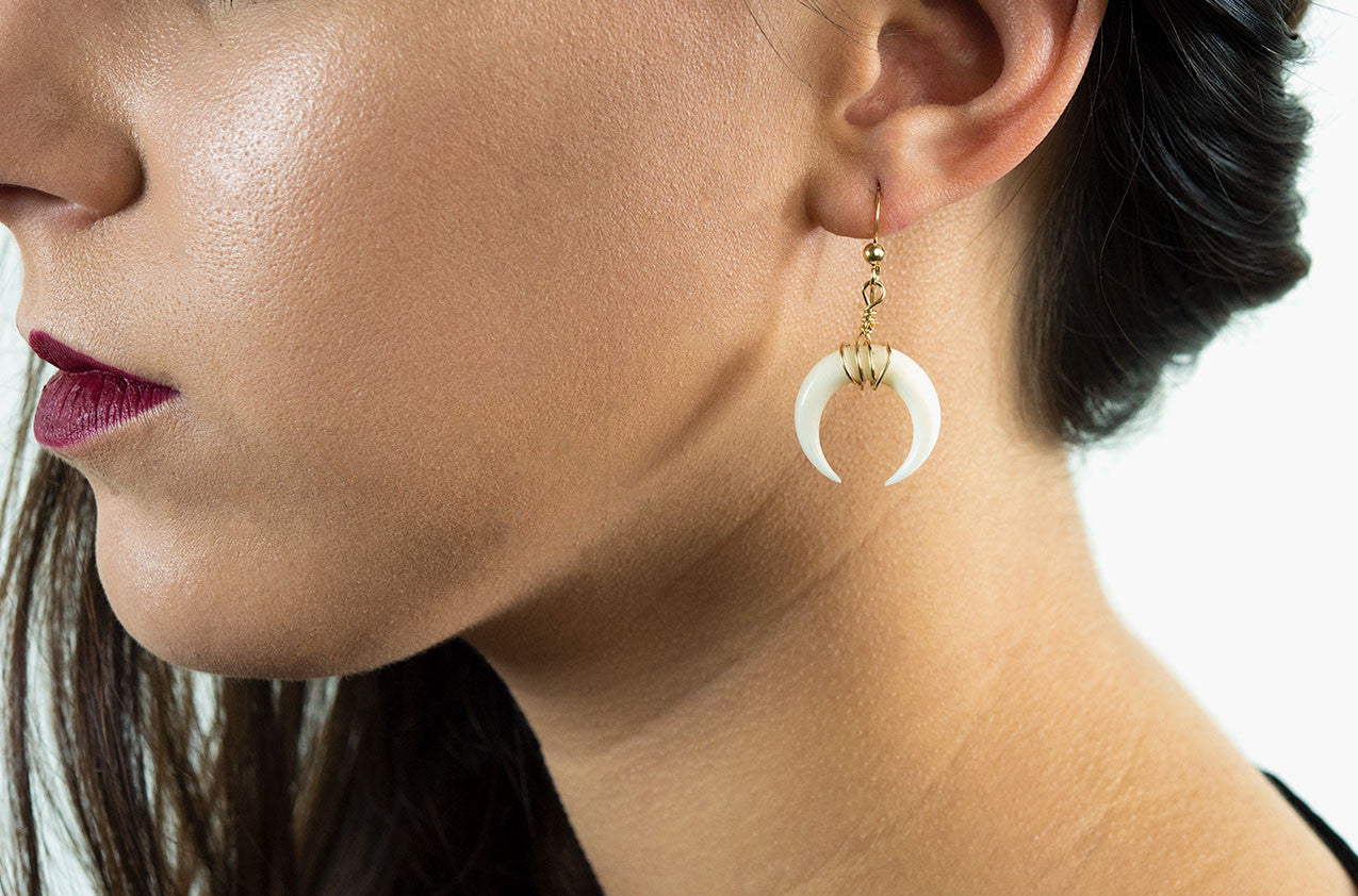 Model wearing Little Big Horn. Crescent medium wire-wrap earrings Ivory with 14kt gold smooth earwires