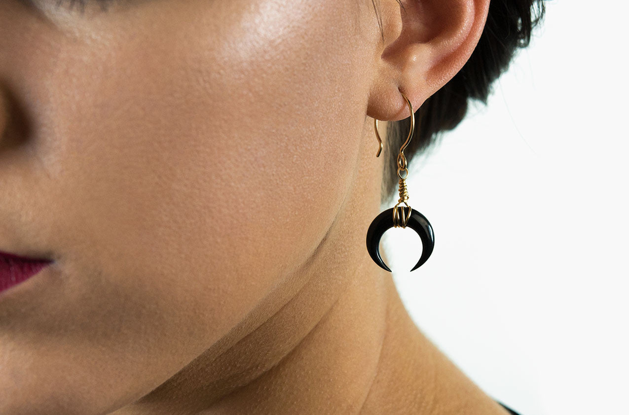 Model wearing Little Big Horn. Crescent mini wire-wrap earrings Black with 14kt gold-filled earwires