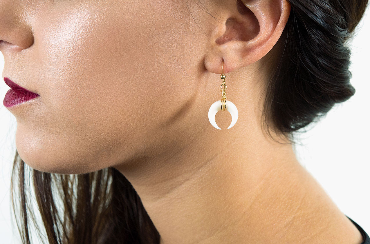 Model wearing Little Big Horn. Crescent mini wire-wrap earrings Ivory with 14kt gold-filled earwires