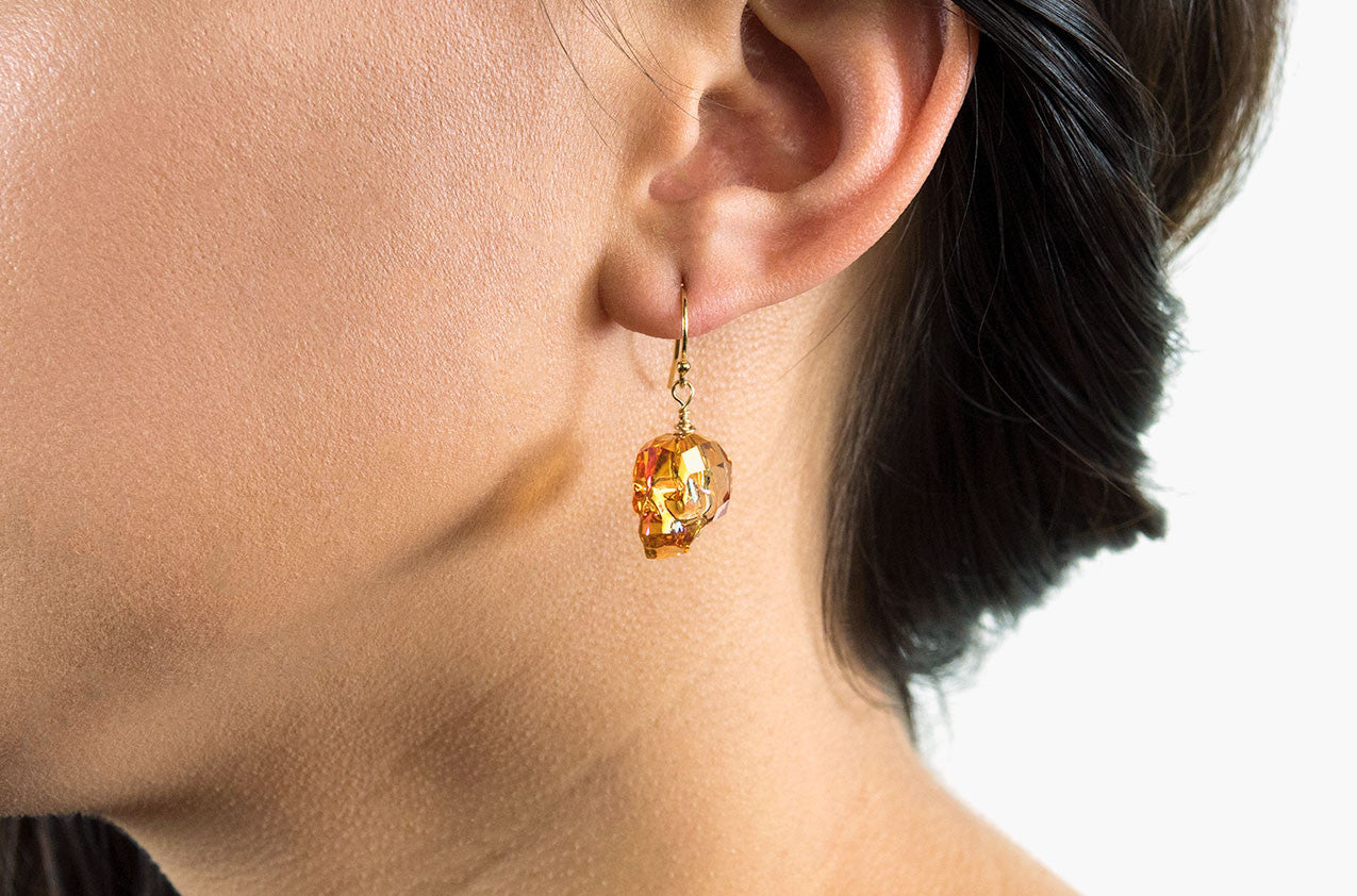 Model wearing Lovely Bones Swarovski Skull earrings Sunshine with 14kt gold filled earwires