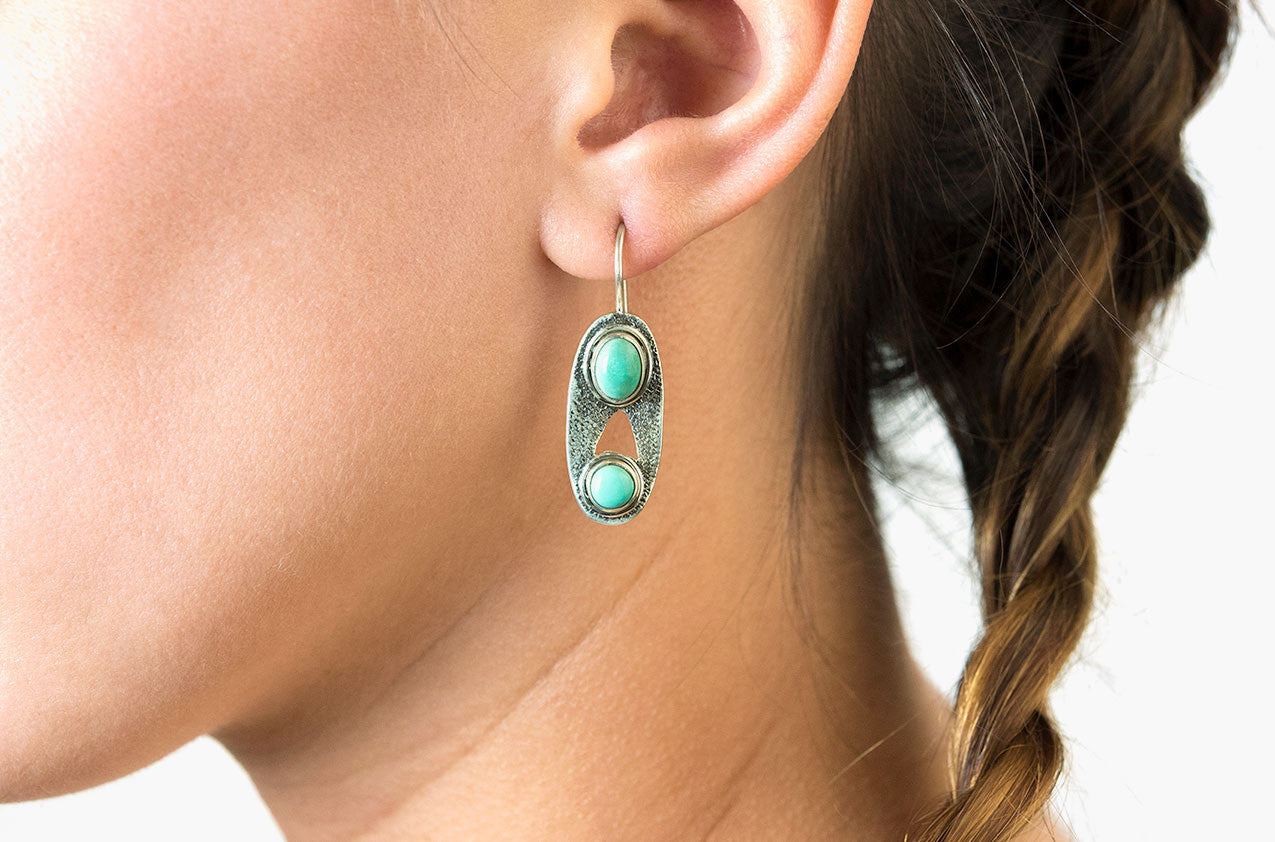 Model wearing Silver & Stone. Oval turquoise earrings