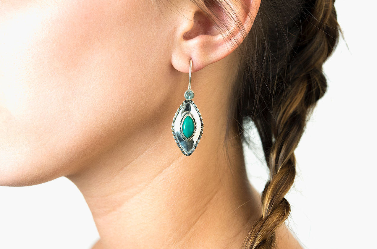 Model wearing Silver & Stone. Topaz and turquoise earrings