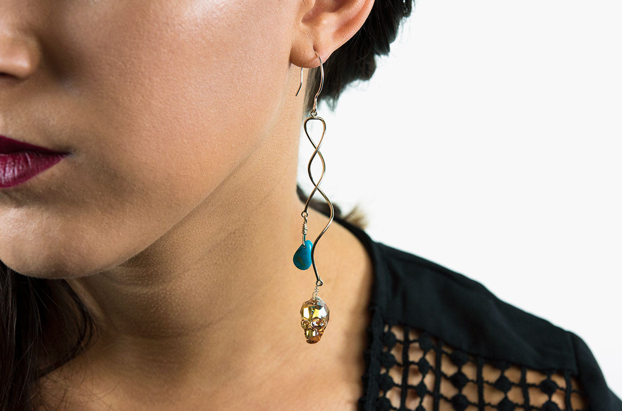 Model wearing Silver, Stone & Bone. Swarovski swirl earrings