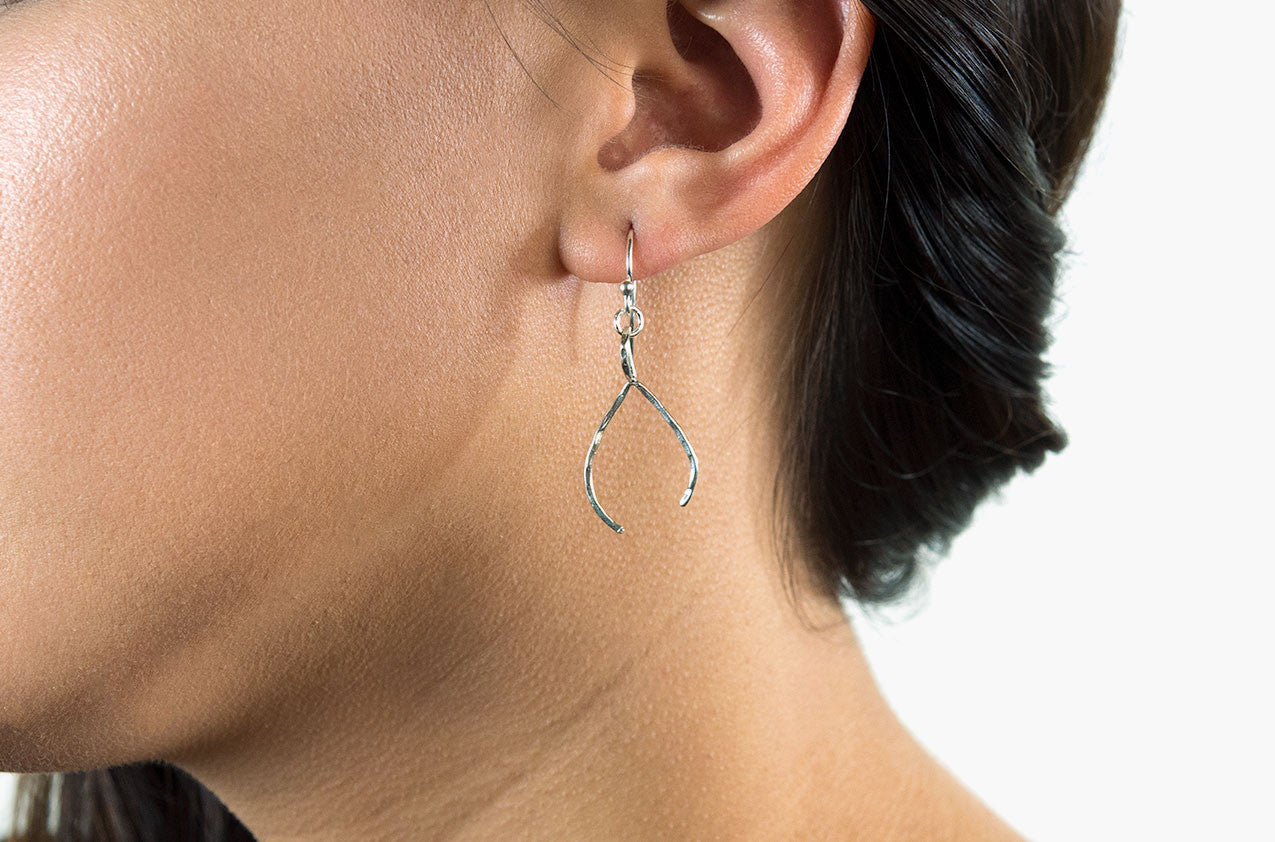 Model wearing Tribal wishbone earrings