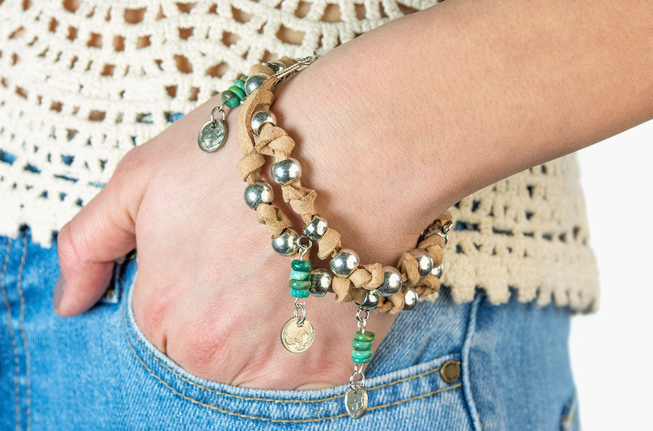 Model wearing Leather, turquoise and coin wrap bracelet