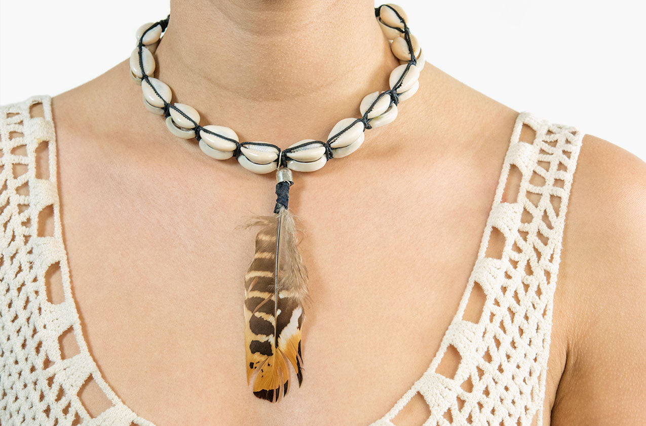 Model wearing Shell and feather necklace