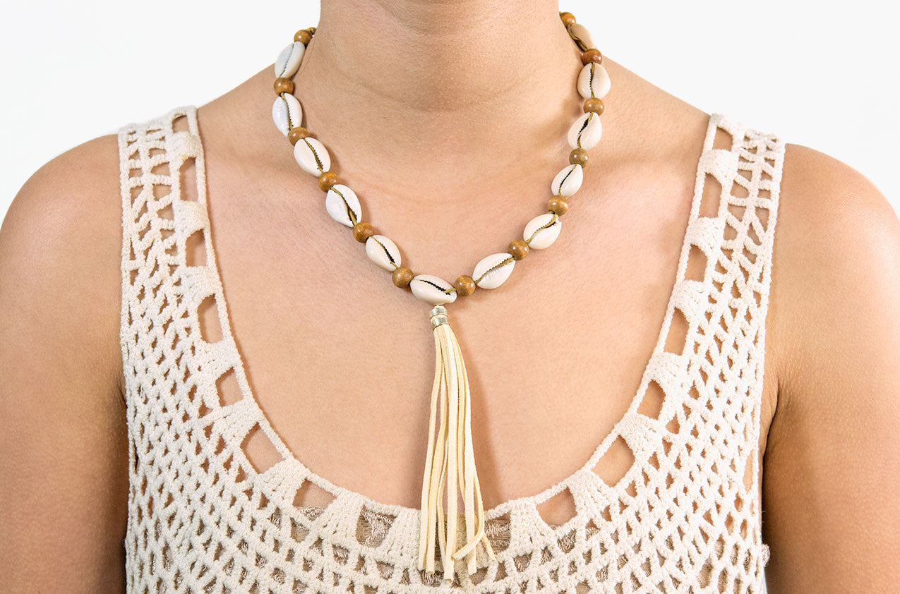 Model wearing Shell, wood and tassel leather necklace