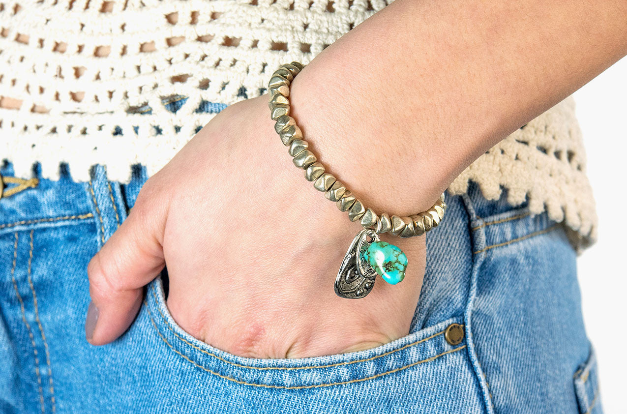 Model wearing Silver nuggets, turquoise and charms bracelet