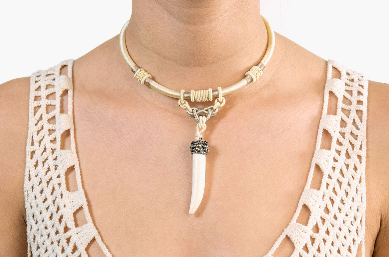 Model wearing Tribal woven necklace with bone spike pendant