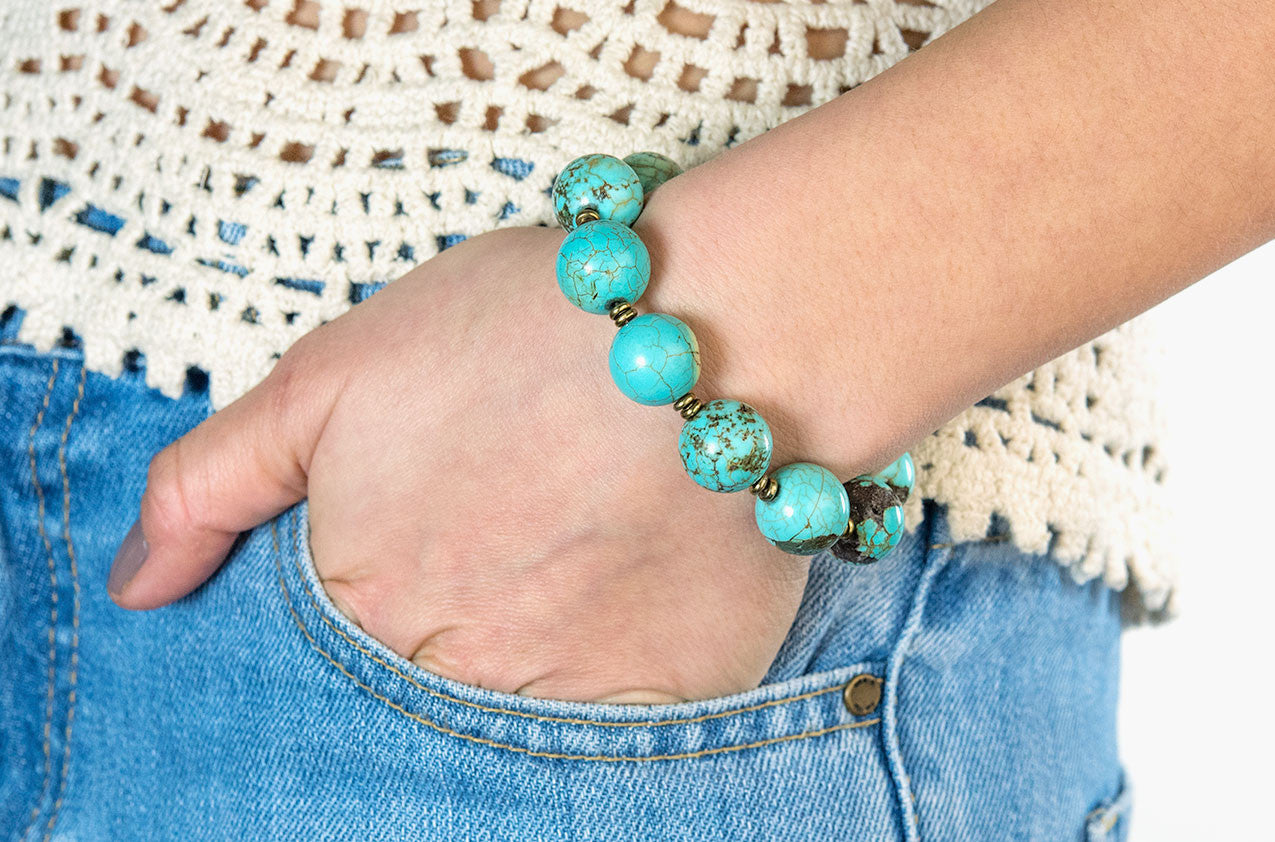 Model wearing Turquoise and brass bracelet